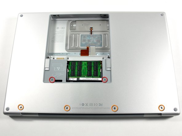 Image 1/1: Two 10 mm T6 Torx screws on either side of the RAM slot.