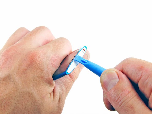 Image 1/3: Lifting up on the iPod opening tool, gently pry the top panel off of the device.