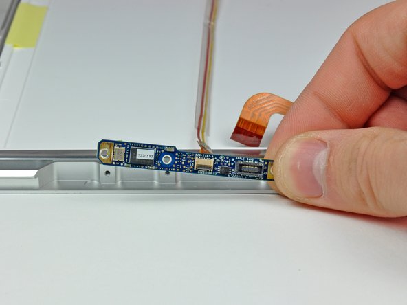 Image 2/2: Remove the camera board from the front display bezel.