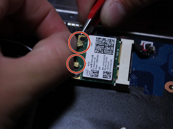 Use the tips of your fingernails and the assistance of your tweezers to remove the snap-on cables from the Wi-Fi card.