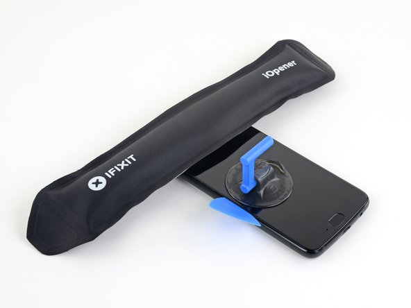 Heat the top edge of the phone with an iOpener.