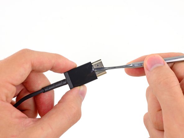 Image 1/3: With a couple flicks of our metal spudger, we find we were right—a hidden IC presents itself!