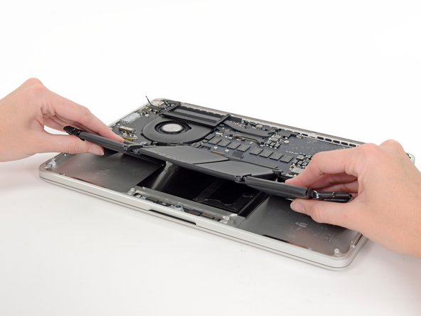 Image 3/3: Victory! At long last, the awkward battery assembly is wrested from the case.