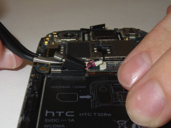 Gently remove the motor from its housing in the phone’s chassis.