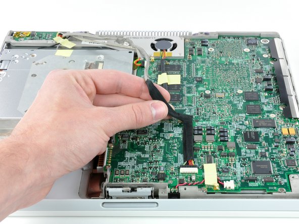 Image 1/2: Disconnect the DC-In cable from the logic board and angle the DC-In board out of its compartment.