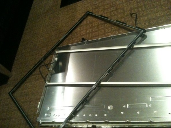 Image 2/3: Once the black surround is off the rest pretty much comes apart with the bottom CCFL tube being able to be removed in a similar manner to the top