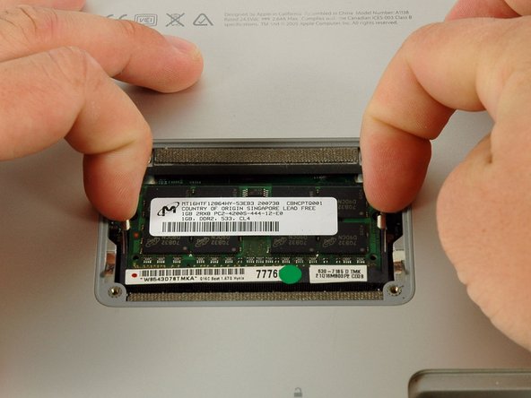 Image 1/1: Pull the chip directly out from its connectors. If there is a second RAM chip installed, pop it out in the same manner.