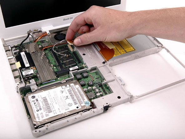 Image 1/1: Disconnect the orange optical drive ribbon from the logic board.