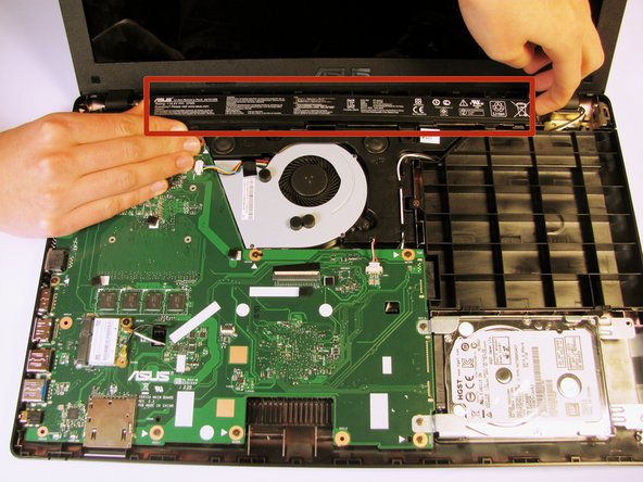 Remove the battery from the laptop by applying pressure on both ends and lifting it out of the case.