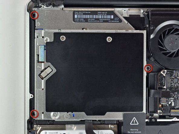 Image 1/2: Lift the optical drive from its right edge and pull it out of the computer.