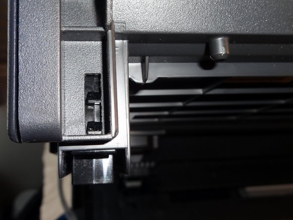 Press the tab to release the clips, then when it's out gently pull towards you to release the back
