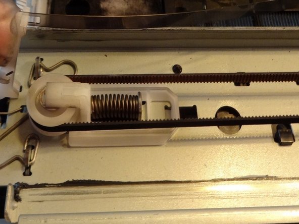 Push the print head unit towards the back of the device and lift the unit from the back rail