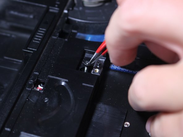 Use your tweezers to remove loosened screws.