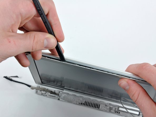 Image 1/2: Rotate the tool away from the LCD to pop the rear bezel off the tabs on the front display bezel.