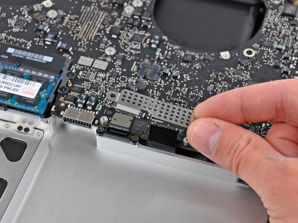 Image 2/2: Remove the EMI shield from the logic board.