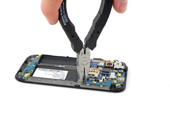 Image 2/2: Once the screw is loosened a bit, you can probably back it out the rest of the way using a screwdriver.