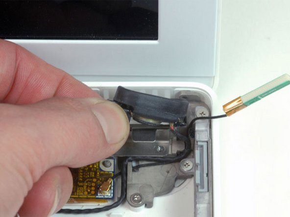 Lift the right speaker out of its housing and set it to the side.