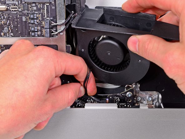 Image 1/1: Remove the optical drive fan from the iMac.