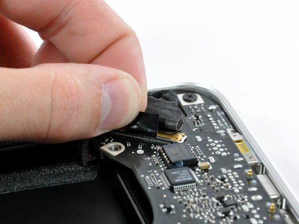 Image 1/2: Pull the display data cable connector straight away from its socket.