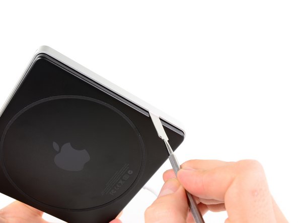 Image 1/2: Continue until all of the clips have been disengaged and the lower case is free.