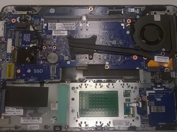Image 1/1: You'll notice that the top of this unit has spill damage to the systemboard, speakers, and top cover.