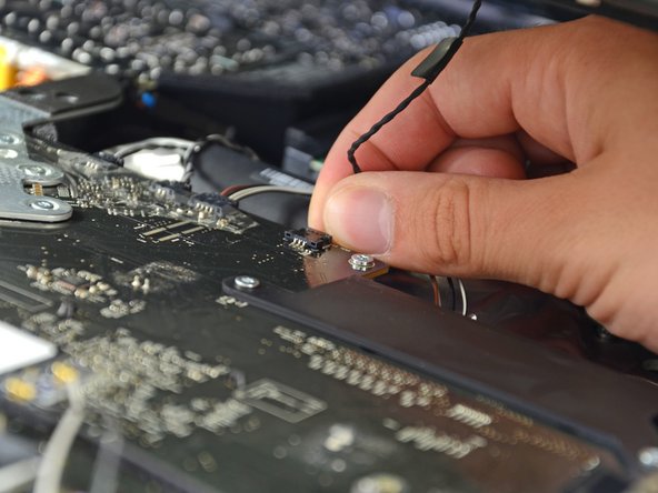 Do not try to remove the display panel completely as it is still connected to the rest of the device.