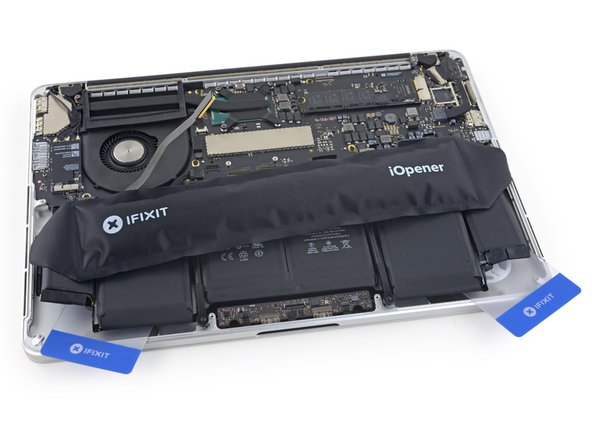 If using an iOpener, reheat it and apply it to the central battery cells.