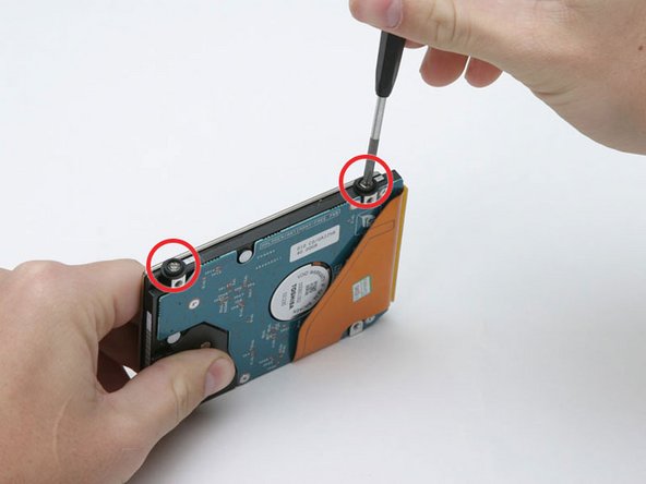 Image 1/1: Lift the metal bracket off of the hard drive.