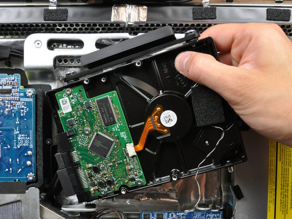 Image 2/2: When reinstalling your hard drive, be careful not to push the rubber grommets through the openings in the chassis with the lower hard drive pins as retrieving them may require logic board removal.