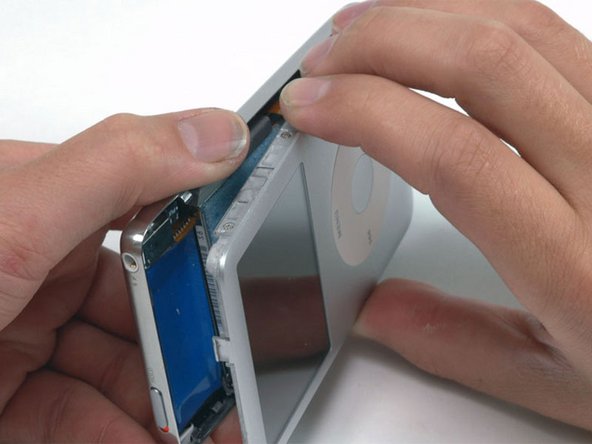 There are two ribbon cables connecting the rear panel to the rest of the iPod. In the following step, be careful not to damage these ribbon cables.
