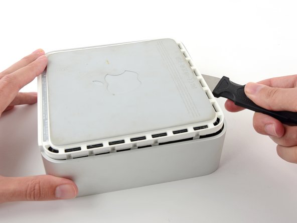 Use the same prying motion to both bend the clips inward and lift the lower housing up out of the top housing.