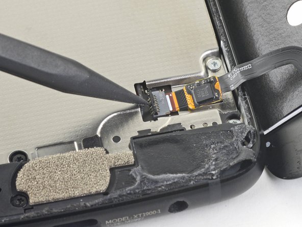 Use tweezers to carefully slide the fingerprint sensor cable out of the socket.