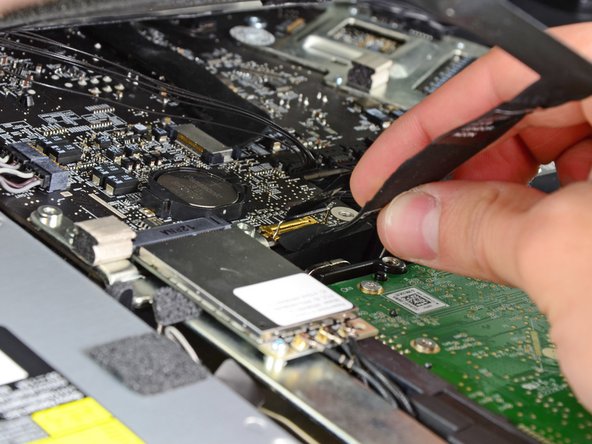 Image 3/3: Do not lift up on the display data cable, as its socket is very fragile. Pull the cable parallel to the face of the logic board.