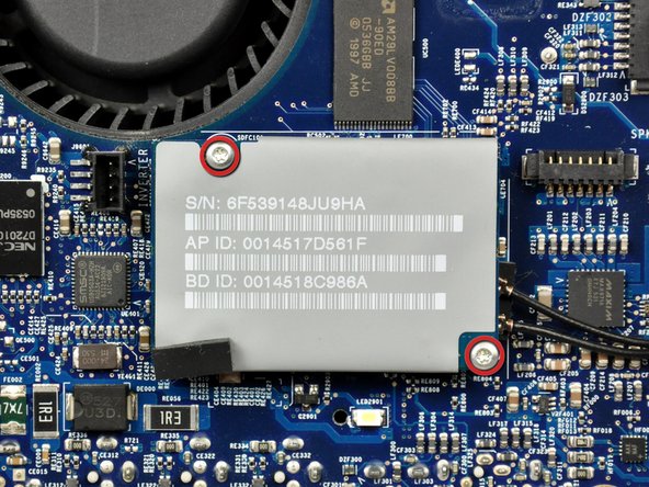 Image 1/2: Lift the AirPort/Bluetooth board up from its left edge to separate it from its socket on the logic board.
