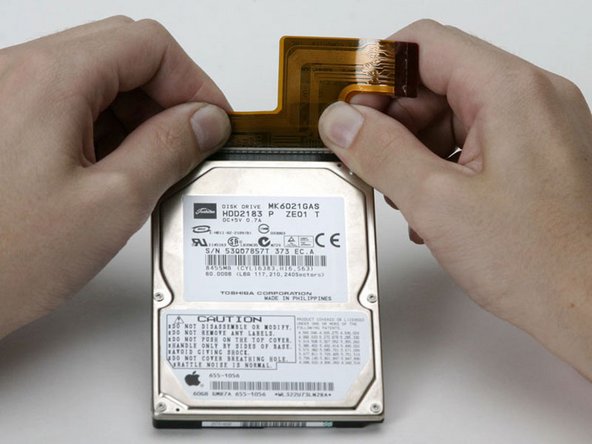 Image 1/1: This is a bit tricky. Try holding the drive against your body while pushing the cable away from you, or rocking the cable gently from side to side while applying even pressure, or both. If you bend the pins, do your best to straighten them, using the hard drive cable as a guide.
